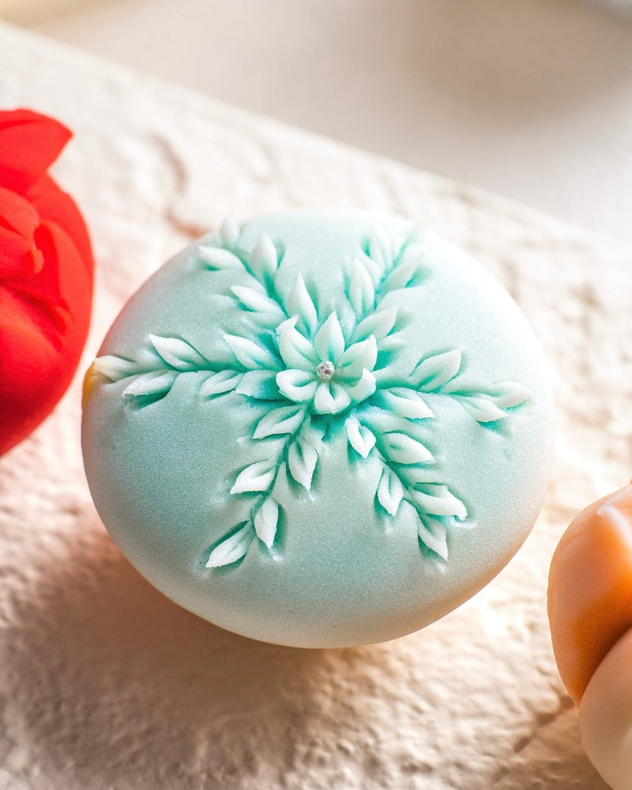 Pale teal nerikiri carved with a snowflake motif